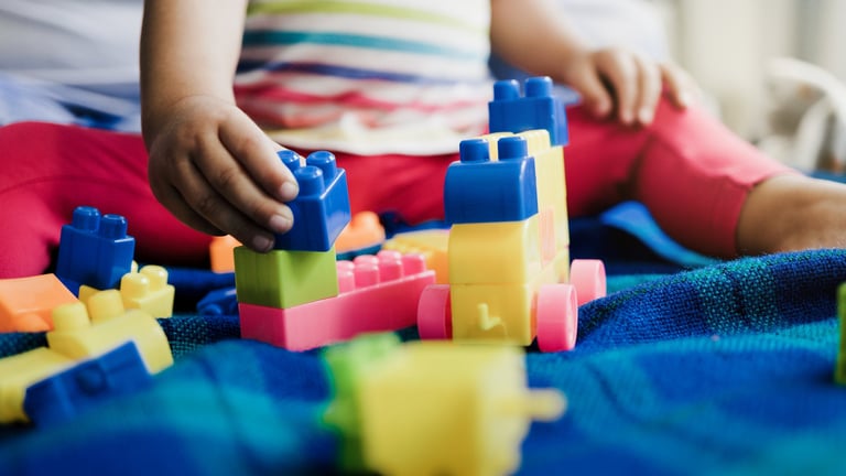 Child playing with soft colorful toys